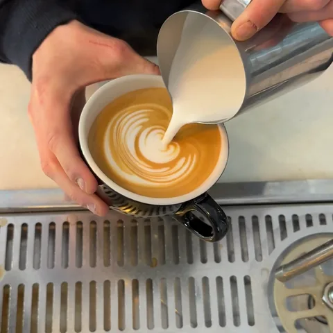 Latte art poured into a cup