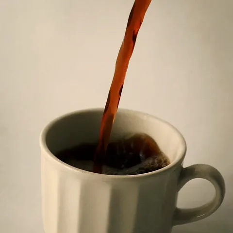 Coffee poured into a cream cup