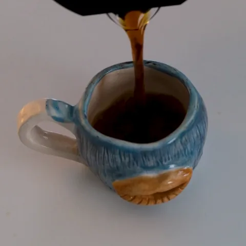 Coffee poured into a blue ceramic mug