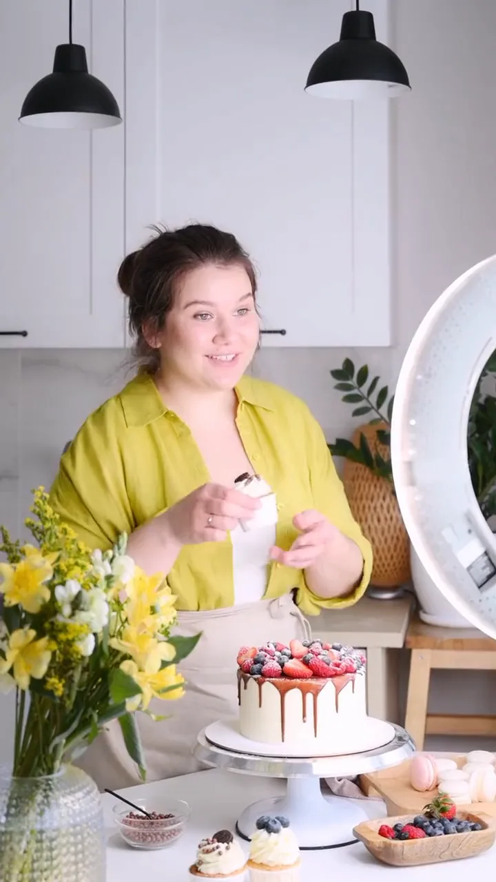 A woman filming the cakes she baked