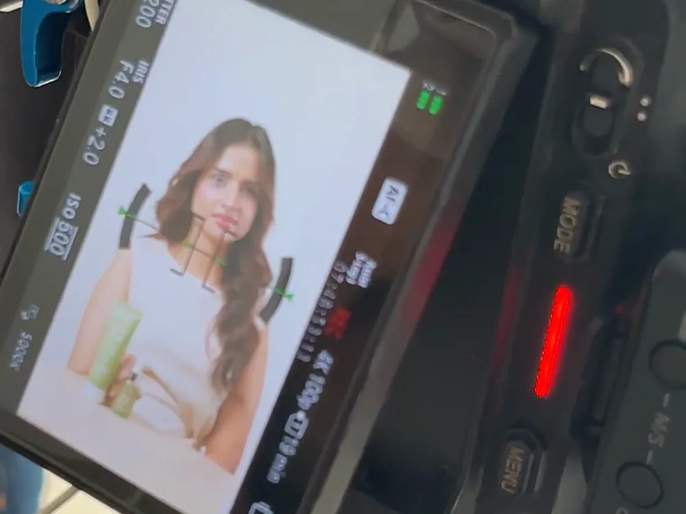 A camera monitor framing a product shoot