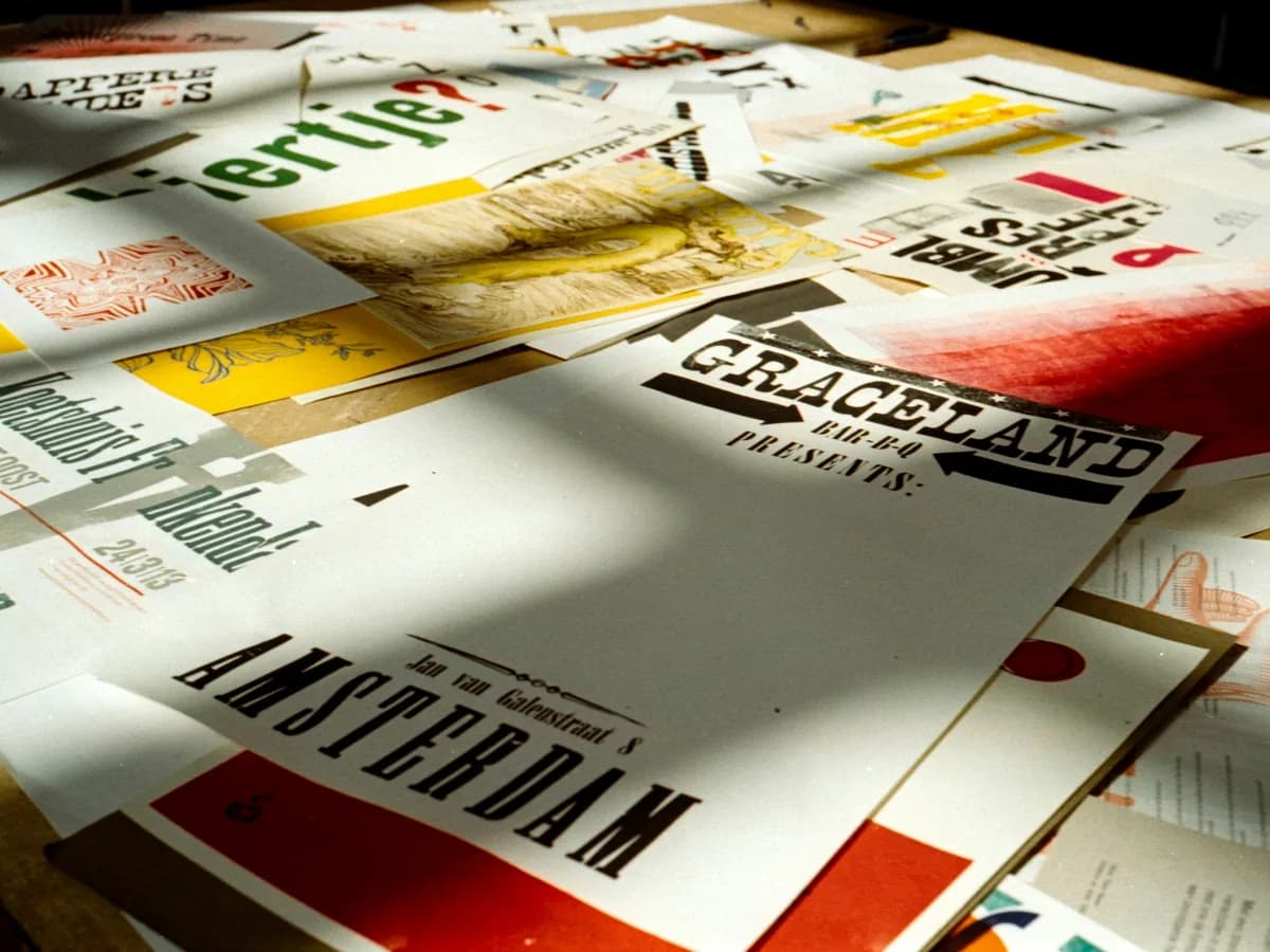 Printed posters and flyers spread across a table