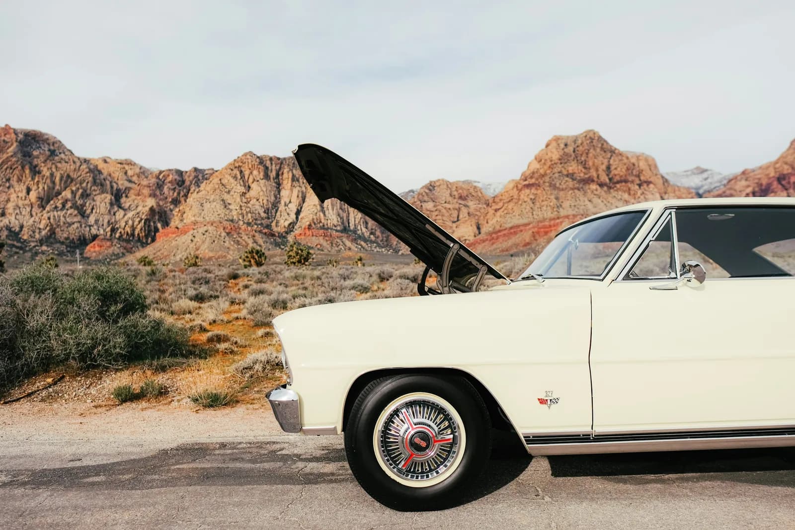 The same car with its hood open, closer in