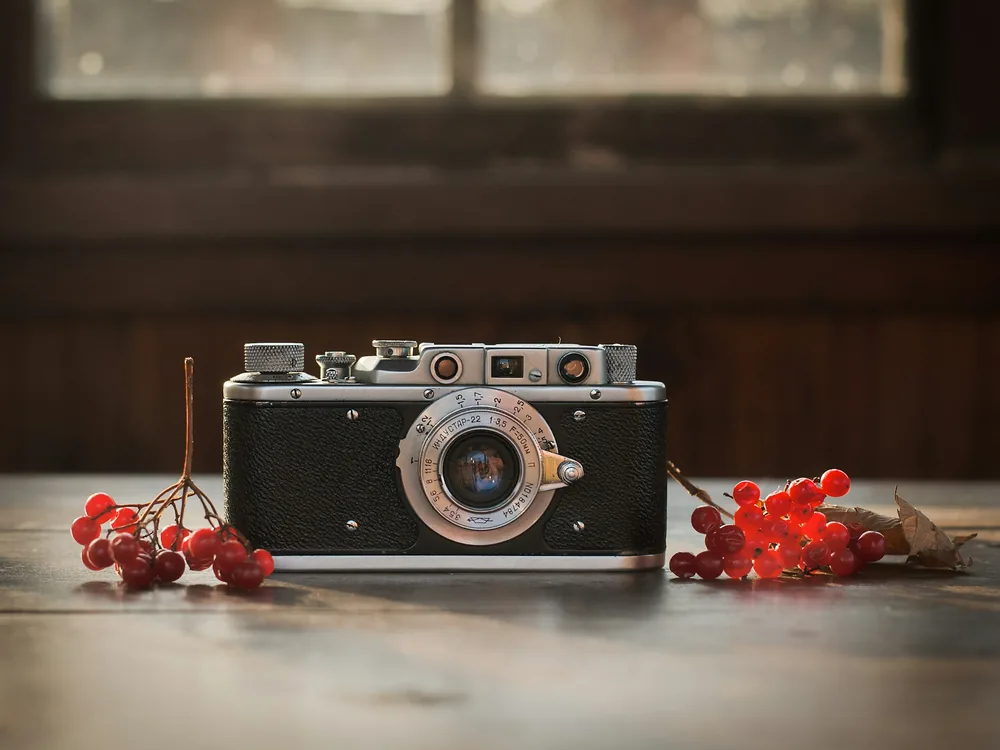 A vintage camera on a wooden table