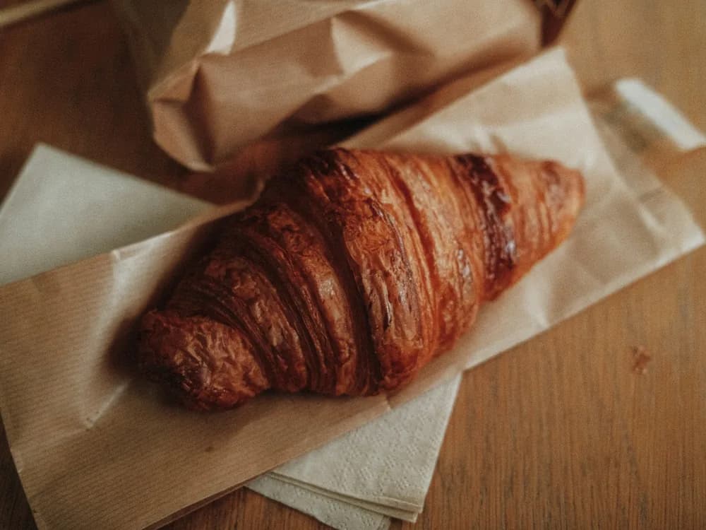 A croissant on a paper bag
