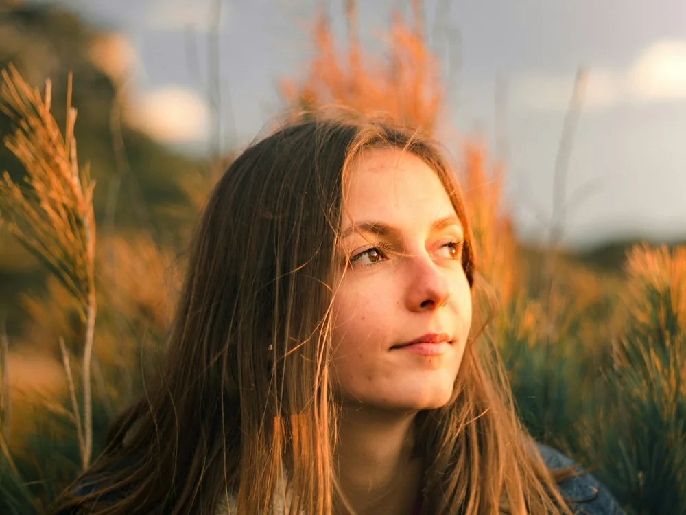 A woman in a field of tall grass