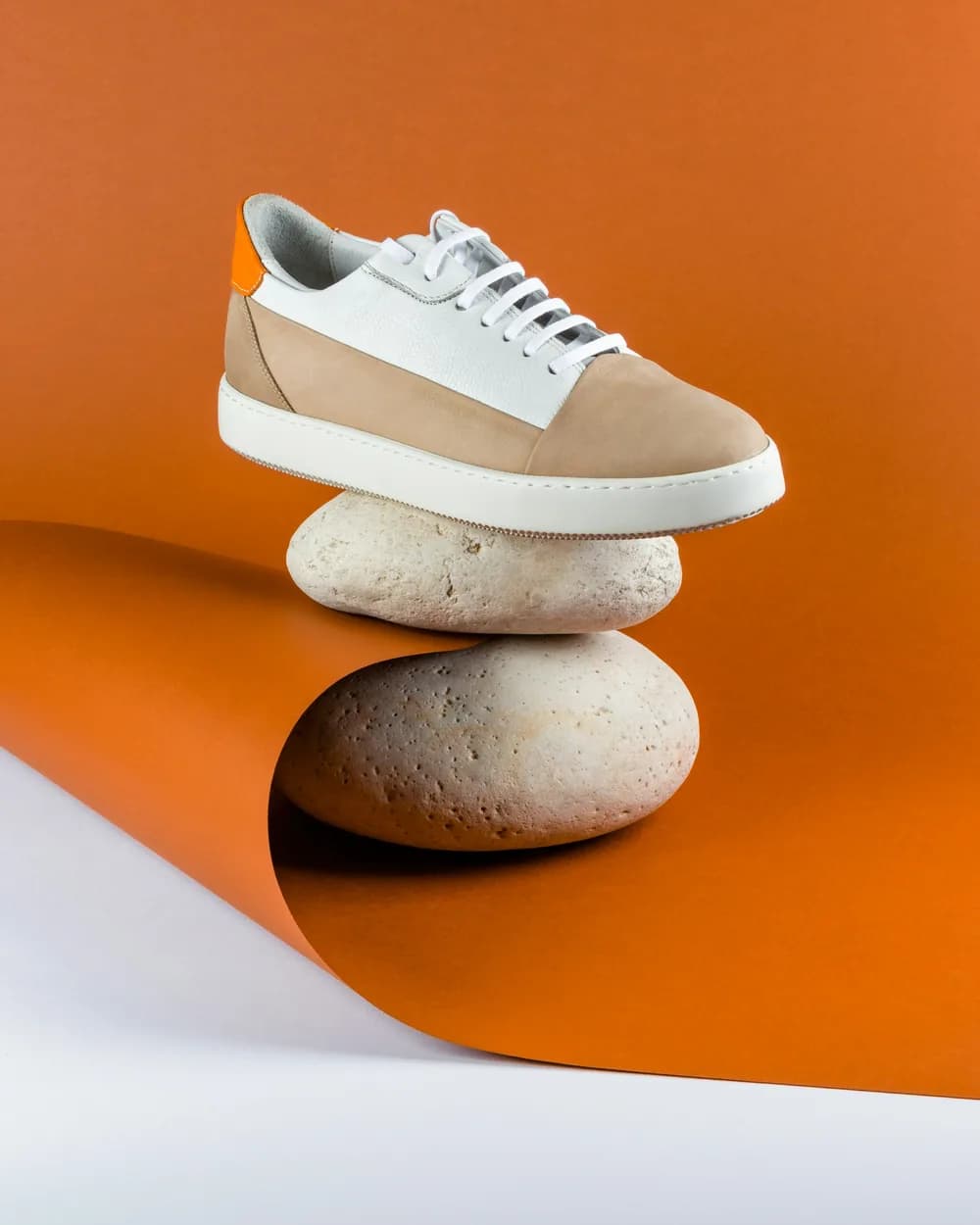 The same sneaker balanced on two stones