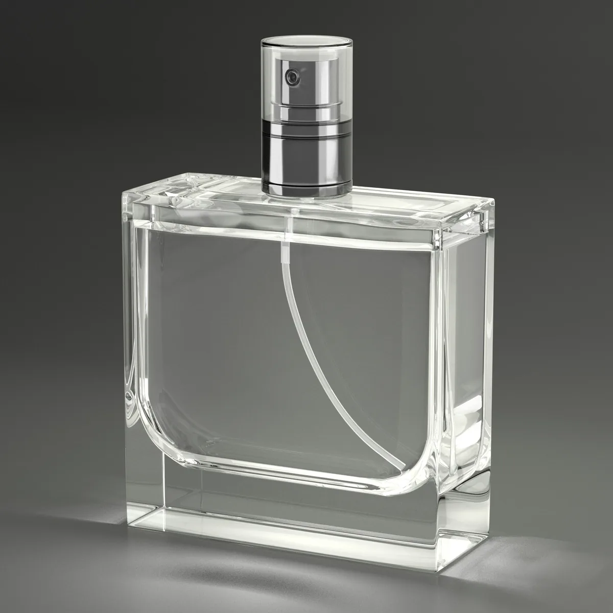 A clear glass perfume bottle on grey