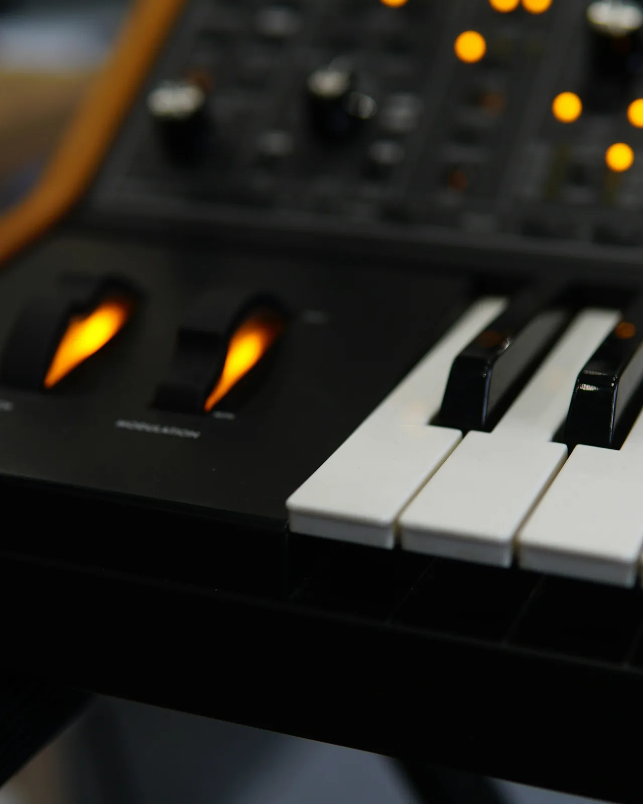 Synthesizer keys and glowing knobs