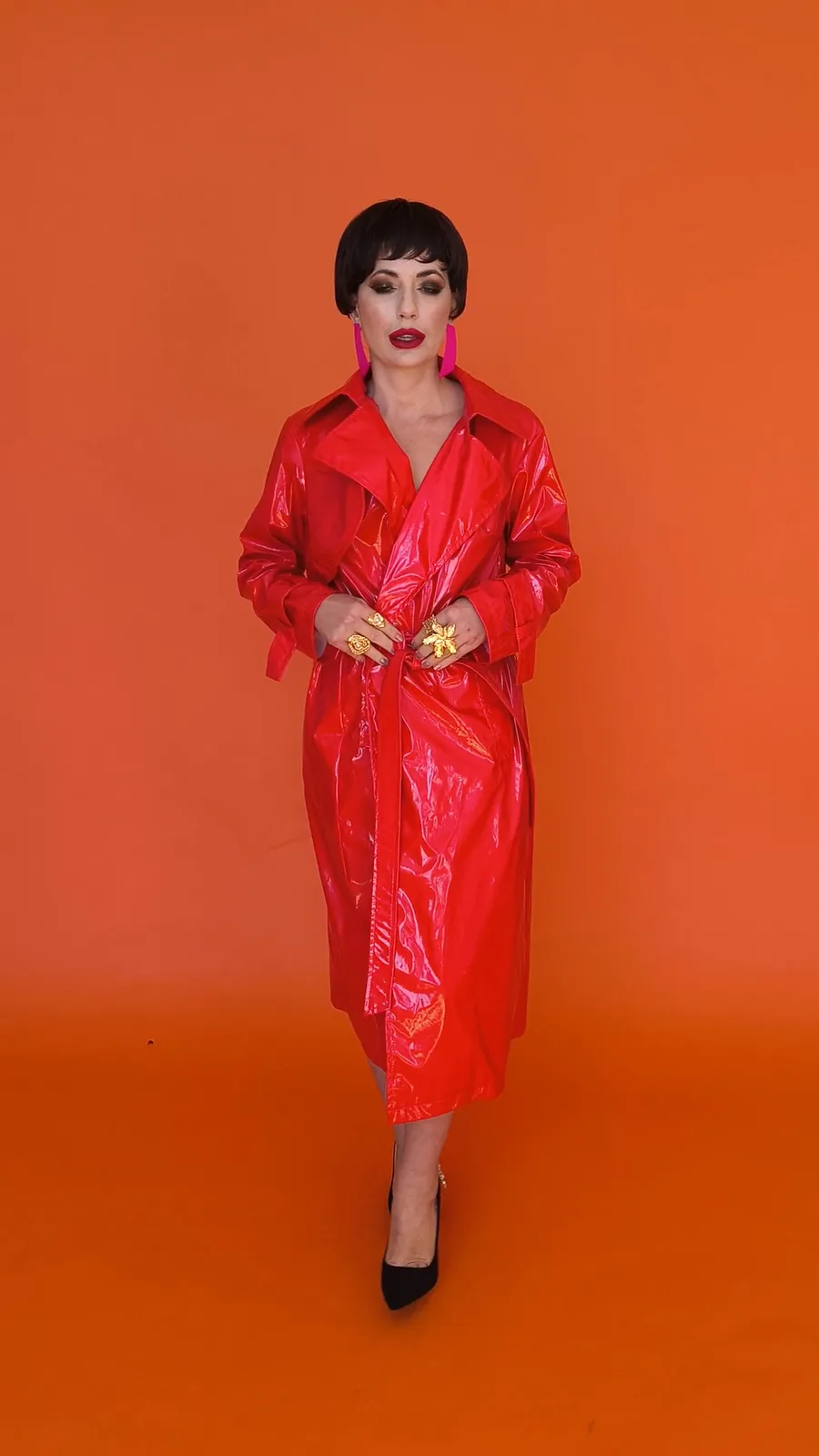A red vinyl trench coat