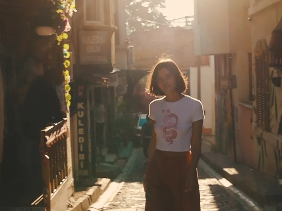A woman in a sunlit alley