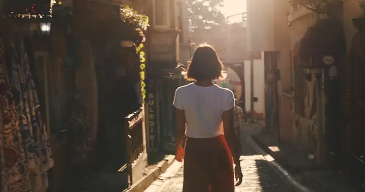 A woman in a sunlit alley