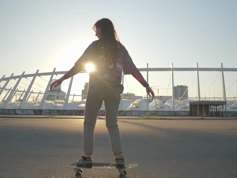 A skateboarder against the sun