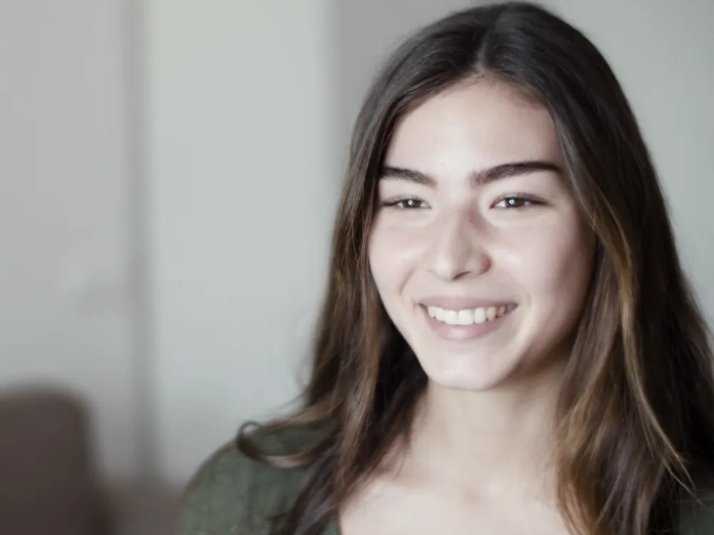 A woman smiling at home