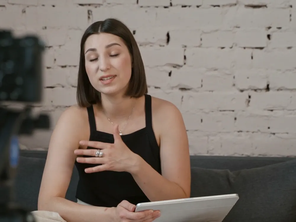 A woman recording a video to camera