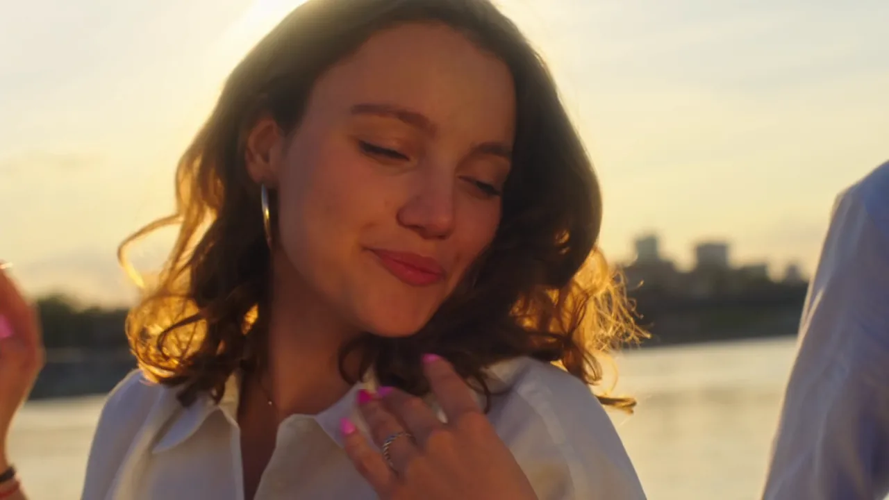 A woman smiling in golden evening light