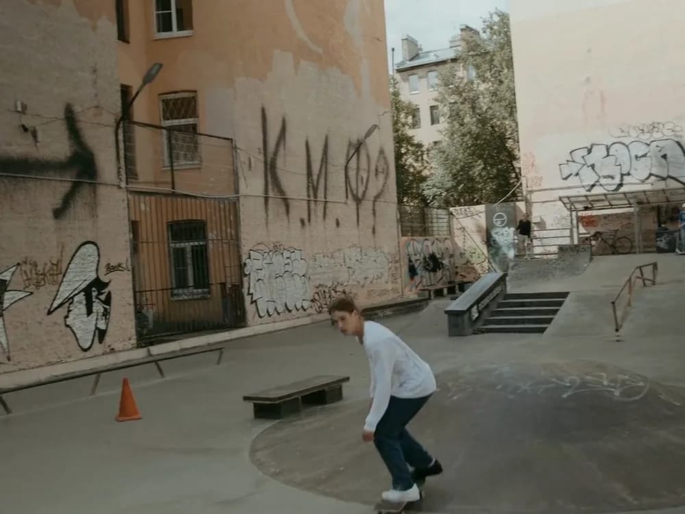 A skate park with graffiti on an old wall