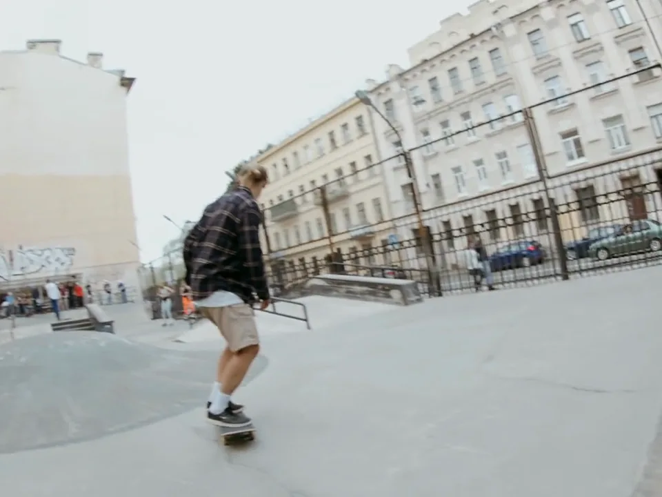 A skater crossing a concrete skate park