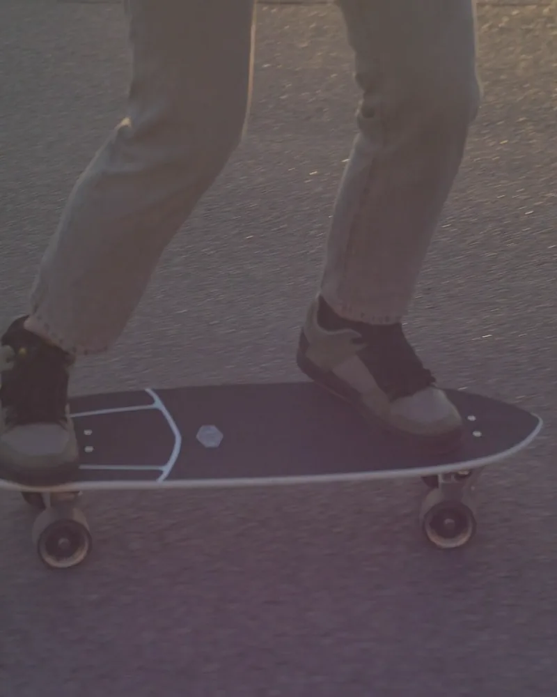 A skater’s legs on a longboard