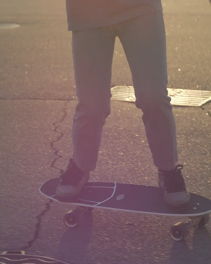 The skater stepping onto the board