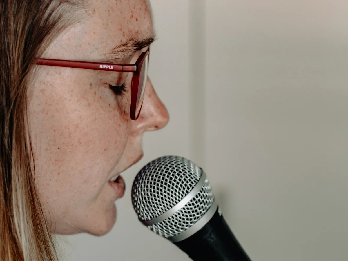 A woman speaking into a microphone